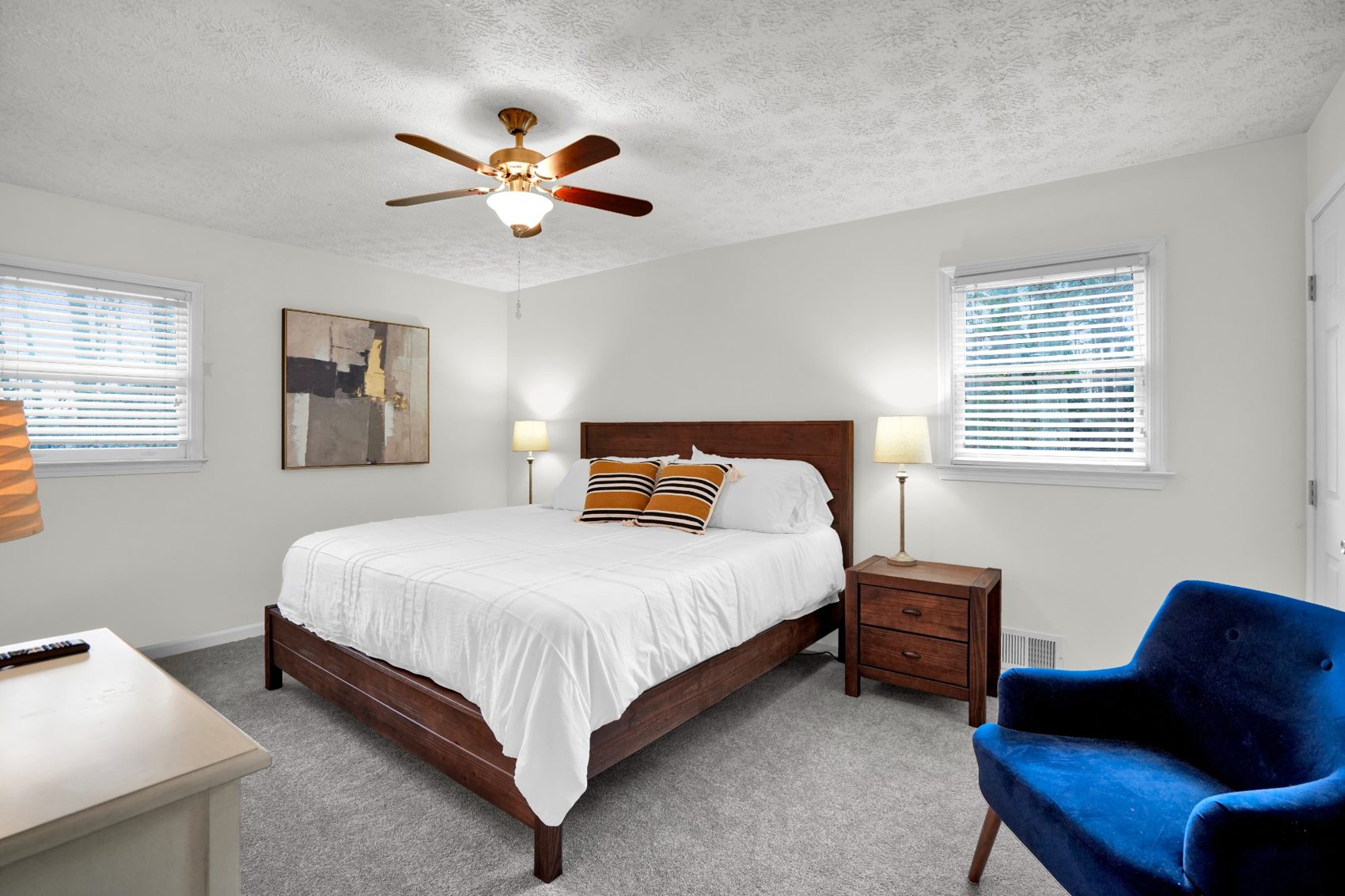 Primary bedroom with king bed and white bedding